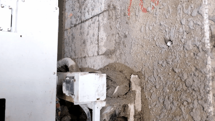 WEIBUILD plastering robot in operation during construction work.